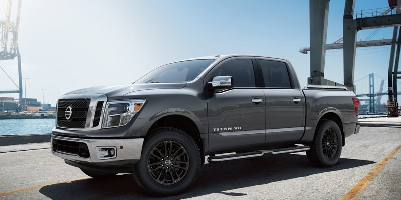 Nissan Titan pickup truck parked on a paved lot at a harbor