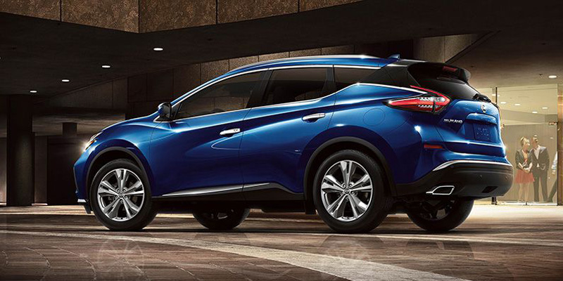 Rear three-quarter view of a Nissan SUV parked in a garage